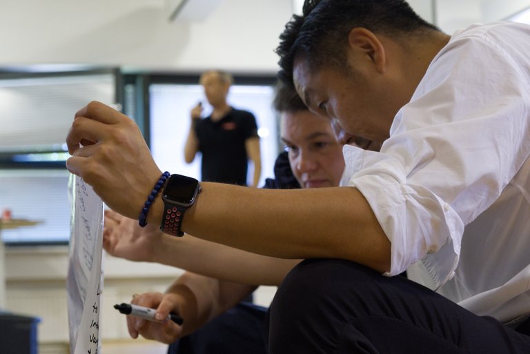 Tuxera employee writing notes in a workshop