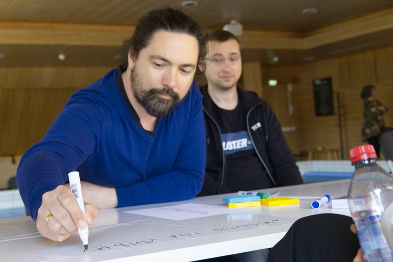 Tuxera employee drawing ideas in a workshop