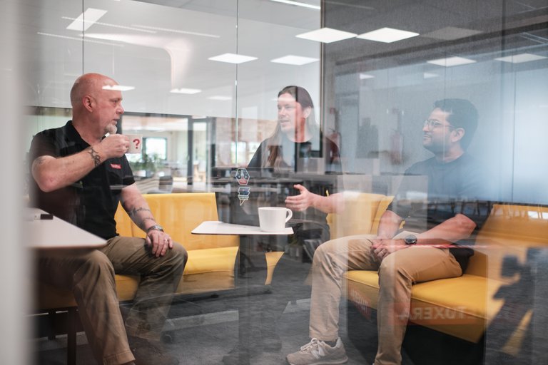 Tuxera colleagues talking over coffee