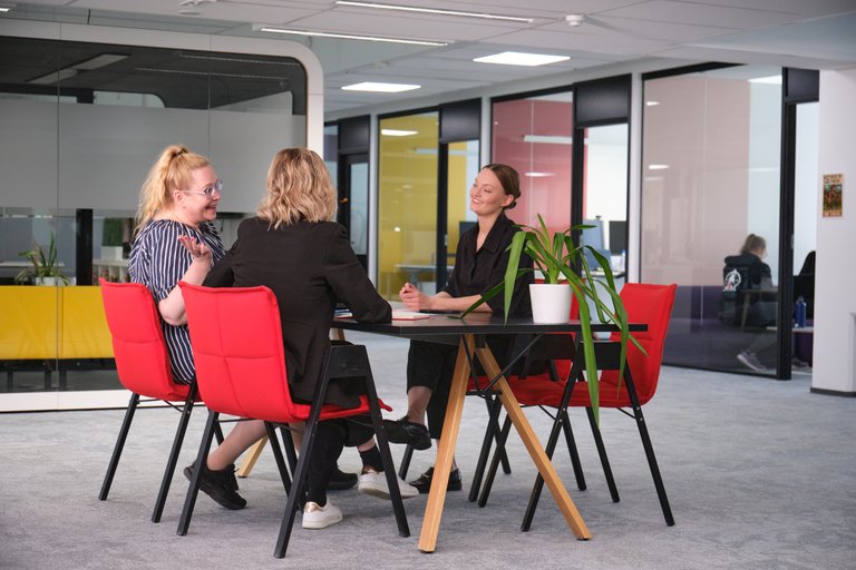 Tuxera colleagues meeting on red chairs